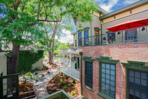 a brick house with a balcony with an umbrella at Notorious Outlaw in Denver