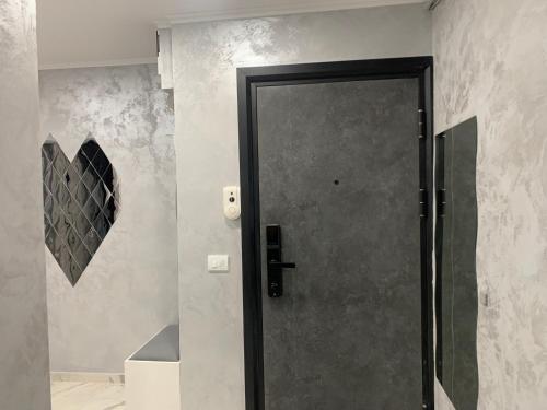 a black door in a bathroom with a wall at Palas Ultraconfort in Iaşi