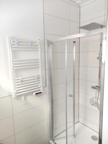 a shower with a glass door in a bathroom at Ferienhaus Sophia 70qm bis 5 Gäste mit Fass-Sauna, Whirlpool April bis Oktober, 75qm Terrasse und eingezäunten Garten in Sierosław