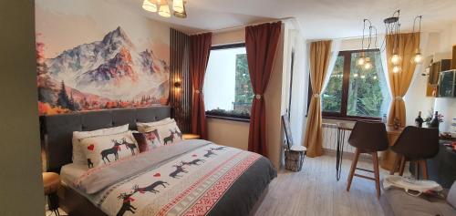 a bedroom with a bed with a painting on the wall at FOX boutique apartment Borovets Gardens in Borovets