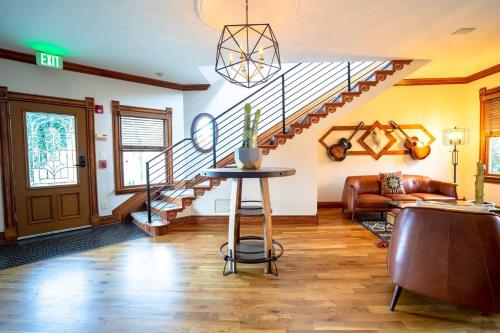 a living room with a staircase and a table at Pinky's Palace in Denver