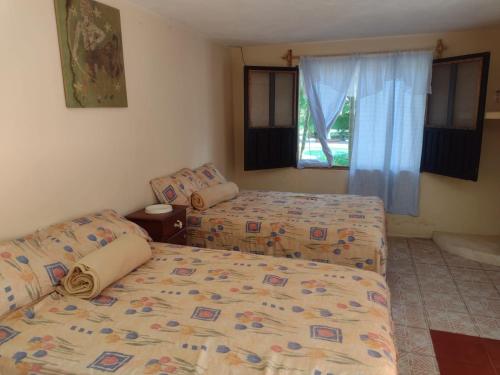 Кровать или кровати в номере Santuario Iguanario
