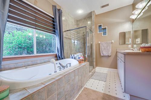 a large bathroom with a tub and a window at Odessa Lake House with Private Pool and Screened Lanai in Odessa