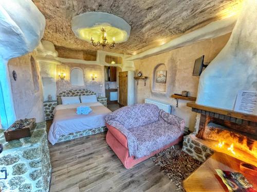 a bedroom with a bed and a fireplace at Anilia Guesthouse in Synikia Mesi Trikalon