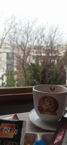 una taza de café sentada en una mesa junto a una ventana en NarPera Taksim Boutique Hotel, en Estambul