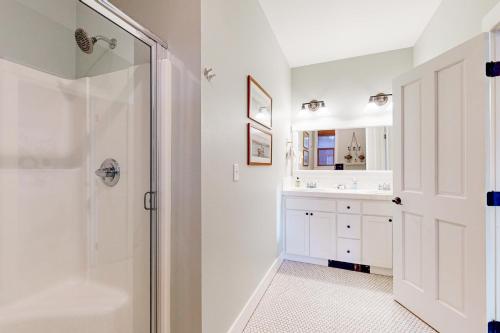 a bathroom with a shower and a sink at Jewel Box at the Beach in Lincoln City