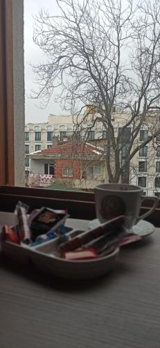 a plate with a cup on a table next to a window at NarPera Taksim Boutique Hotel in Istanbul