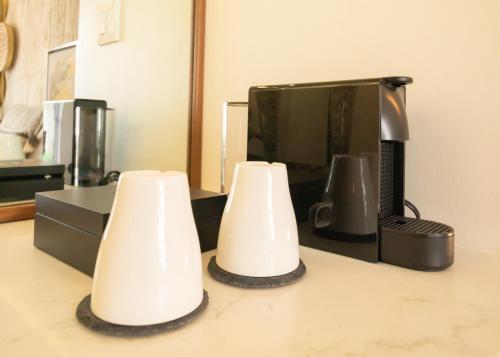 two white lamps sitting on a counter in front of a microwave at Hotel Andana Winery & Spa in Valle de Guadalupe