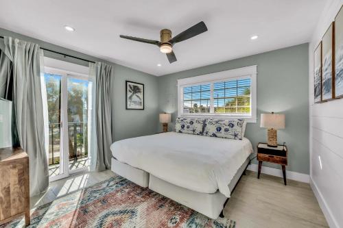 a bedroom with a bed and a ceiling fan at Surf Side in Anna Maria