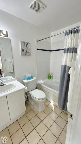 a white bathroom with a toilet and a sink at Mountainview Loft at North Creek Resort in Blue Mountains