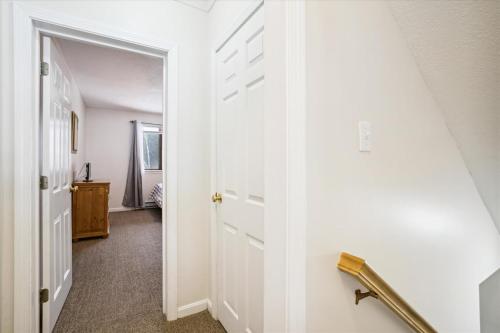 a hallway with a white door leading to a bedroom at Cozy 2-Bedroom Northbrook #3 with Fireplace in Killington