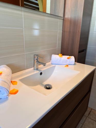 a bathroom with a sink with two towels on it at CASA XAVET, Piscina Privada Aire Acondicionado Free in L'Escala