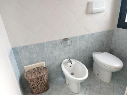 a bathroom with a toilet and a bidet at Casa Minuredda in Olbia