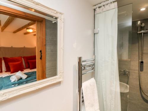 a bathroom with a mirror and a shower at Hay Loft in Camborne