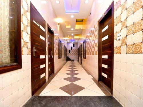 a hallway with a tile floor in a building at Hotel O Max in Jalandhar