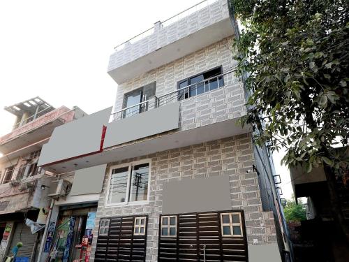 a building with a balcony on top of it at Hotel O Max in Jalandhar