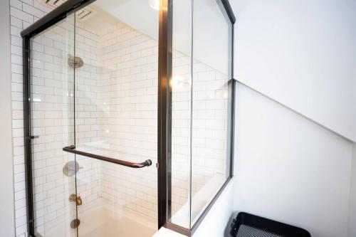 a shower with a glass door in a bathroom at Captivating Cowgirl in Denver