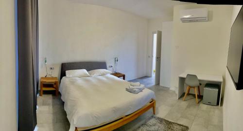 a bedroom with a bed and a desk in it at Agriturismo Al Mancino in Lonato del Garda