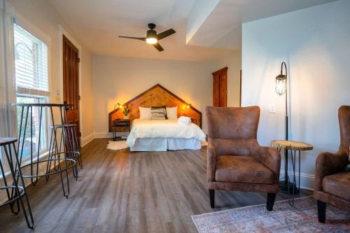 a bedroom with a bed and a chair at The Western Allure in Denver
