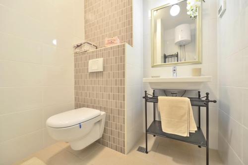 a bathroom with a toilet and a sink and a mirror at Apartment Karlo in Split