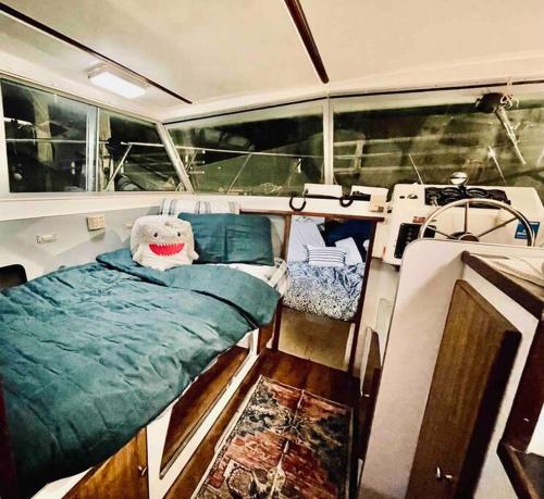 a bed in the middle of a boat at Buffalo’s River Den in Buffalo