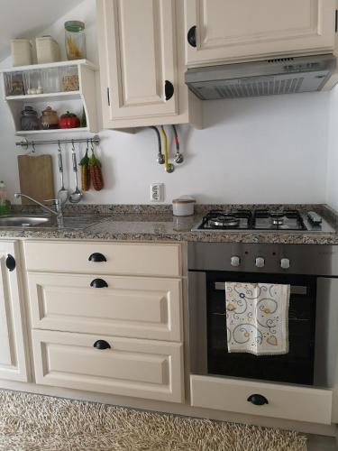a kitchen with white cabinets and a stove at Quinta das Águias in Aveiro
