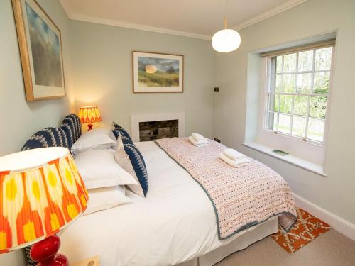 a bedroom with a white bed and a fireplace at The Manse - Uk42249 in Broughton