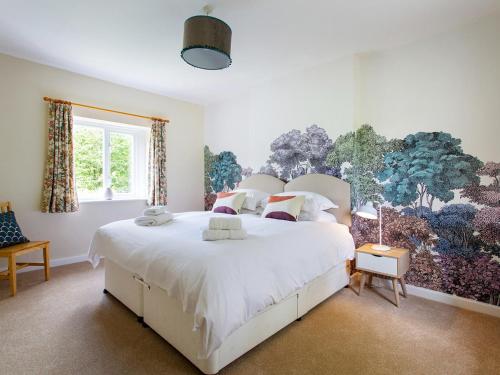 a bedroom with a large white bed and a window at Gargrave Cottage - Uk42248 in Broughton