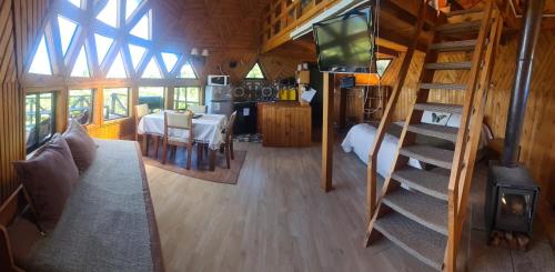 a living room with a staircase in a tiny house at Turismo del Bosque in Castro