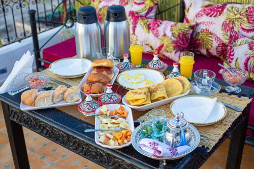 a table topped with plates of food and drinks at Riad Soultan in Fès