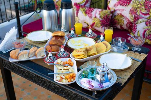 a table topped with plates of food and drinks at Riad Soultan in Fès