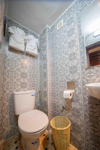 a bathroom with a toilet and a sink at Riad Soultan in Fès
