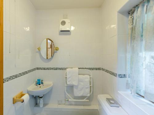 a white bathroom with a sink and a toilet at 3 Bed in Bewdley THERR in Highley