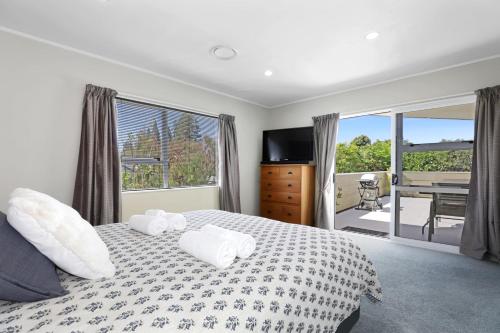 a bedroom with a bed with two towels on it at Stay at 5A in Rotorua