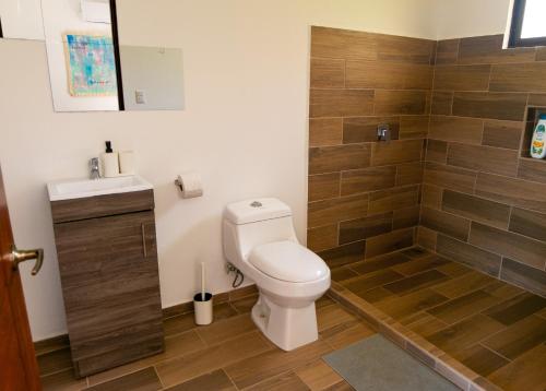 a bathroom with a toilet and a shower at MY - Cosy Lodges in Paraíso