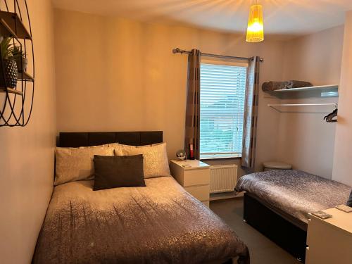 a small bedroom with a bed and a window at House in Hemingfield in Wombwell