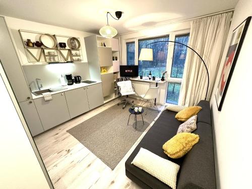 a living room with a couch and a desk at COZY Studio at PARK near CITY-Center +NETFLIX +WIFI in Warsaw