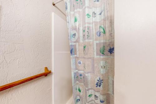 a shower curtain with butterflies on it in a bathroom at Nye Beach Condo in Newport