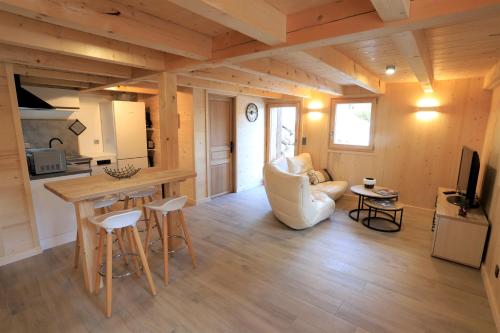 a kitchen and living room with a table and chairs at Chalet du Bonheur in Saint-Gervais-les-Bains