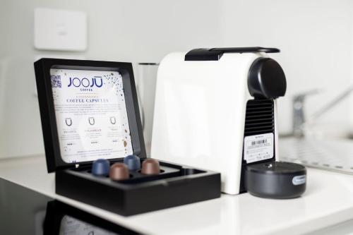 a counter top with a toothbrush and a hair dryer at Durham Serviced Apartments in Adelaide