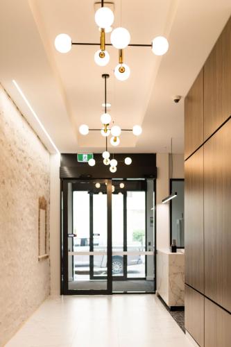 an office hallway with a door and a chandelier at Durham Serviced Apartments in Adelaide