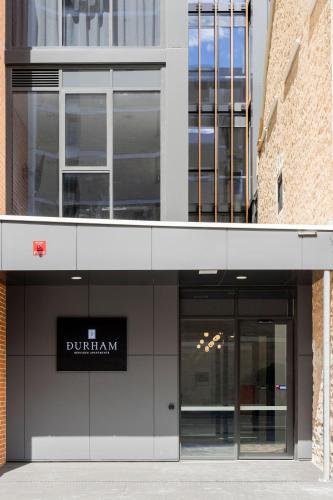 a building with a sign that reads durham at Durham Serviced Apartments in Adelaide