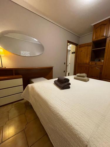 a bedroom with a bed with two towels on it at Varousi House in Tríkala