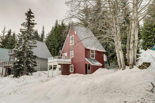 a red house with snow on the ground at Snoqualmie Pass Cabin with Deck Walk to Ski Lift in Snoqualmie Pass