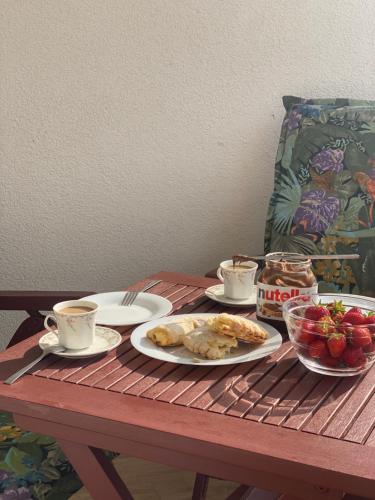 a table with plates of food and cups of coffee at comfort Point in Gorzów Wielkopolski