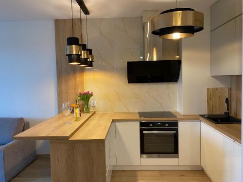 a kitchen with a wooden counter top in a room at comfort Point in Gorzów Wielkopolski