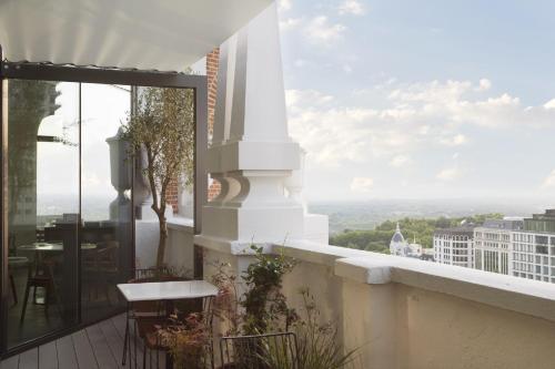 a balcony with a table and a view of the city at Dear Hotel Madrid in Madrid