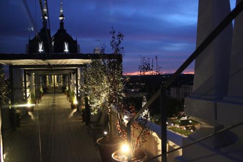 a balcony of a building at night with lights at Dear Hotel Madrid in Madrid
