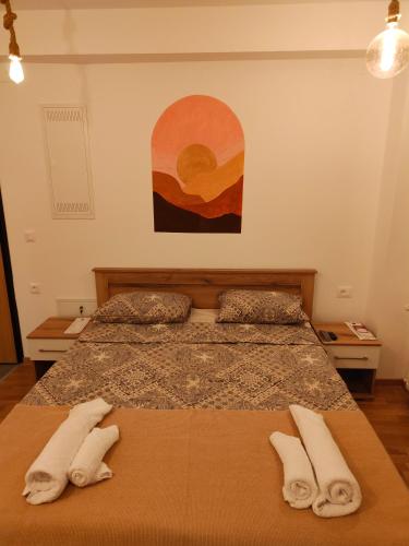 a bedroom with two beds with white towels on them at Boho style in Jagodina