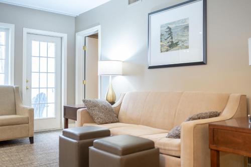 a living room with a couch and a chair at Horseshoe Valley Suites - The Aurora in Shanty Bay